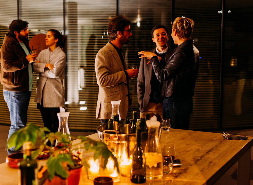 People mingling at an evening networking party